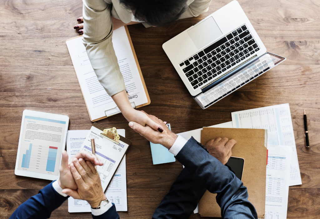 business people shaking hands together 1